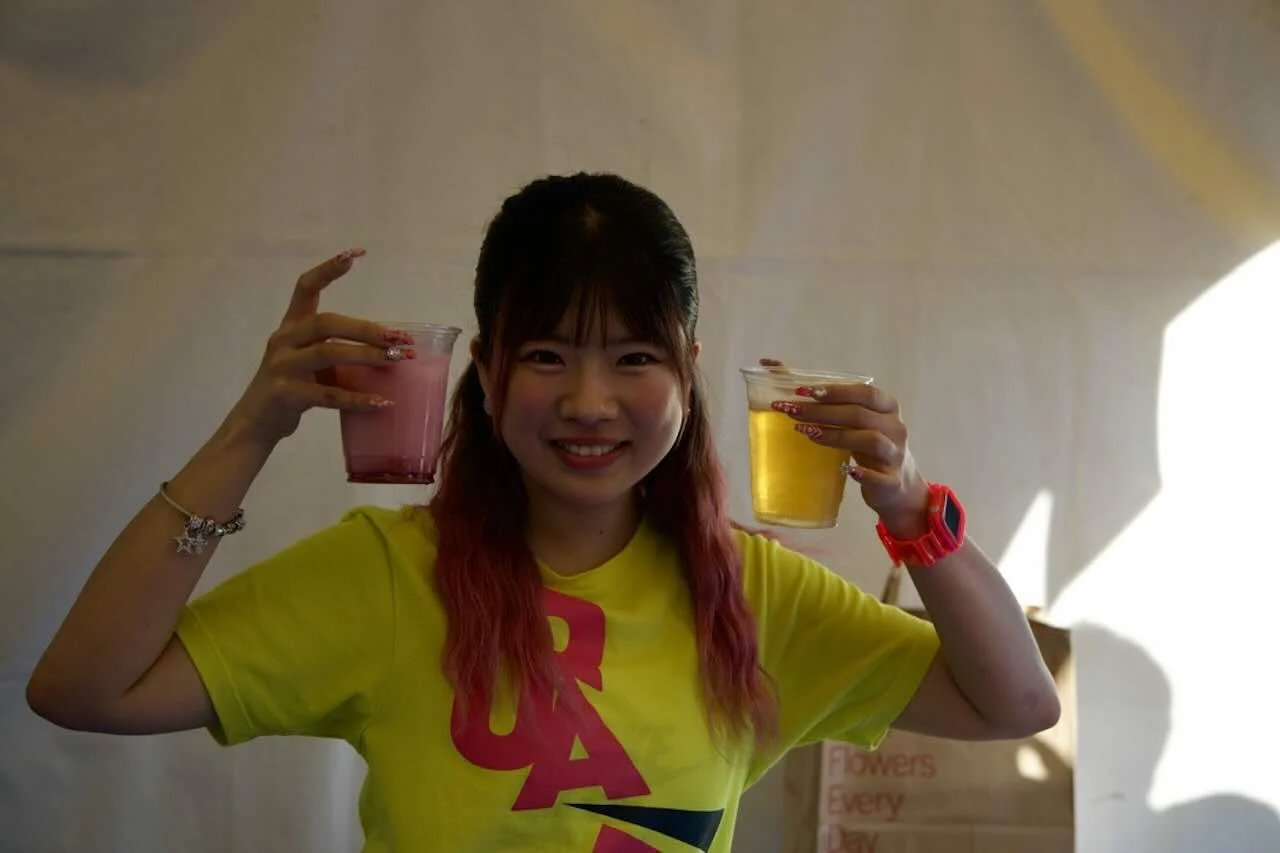 Yuuna posing with a drink at the festival